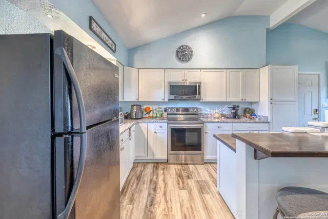 a kitchen with a sink stainless steel appliances and cabinets