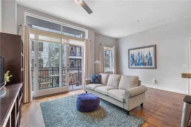 a living room with furniture and a potted plant
