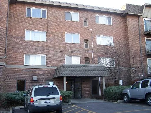 a car parked in front of a brick building