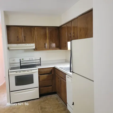 a kitchen with a stove sink and cabinets
