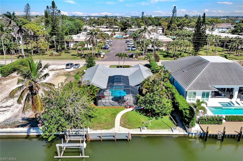 1550 Sandpiper Street Naples, FL 34102 - Photo 31 of 34 an aerial view of house with yard swimming pool and outdoor seating