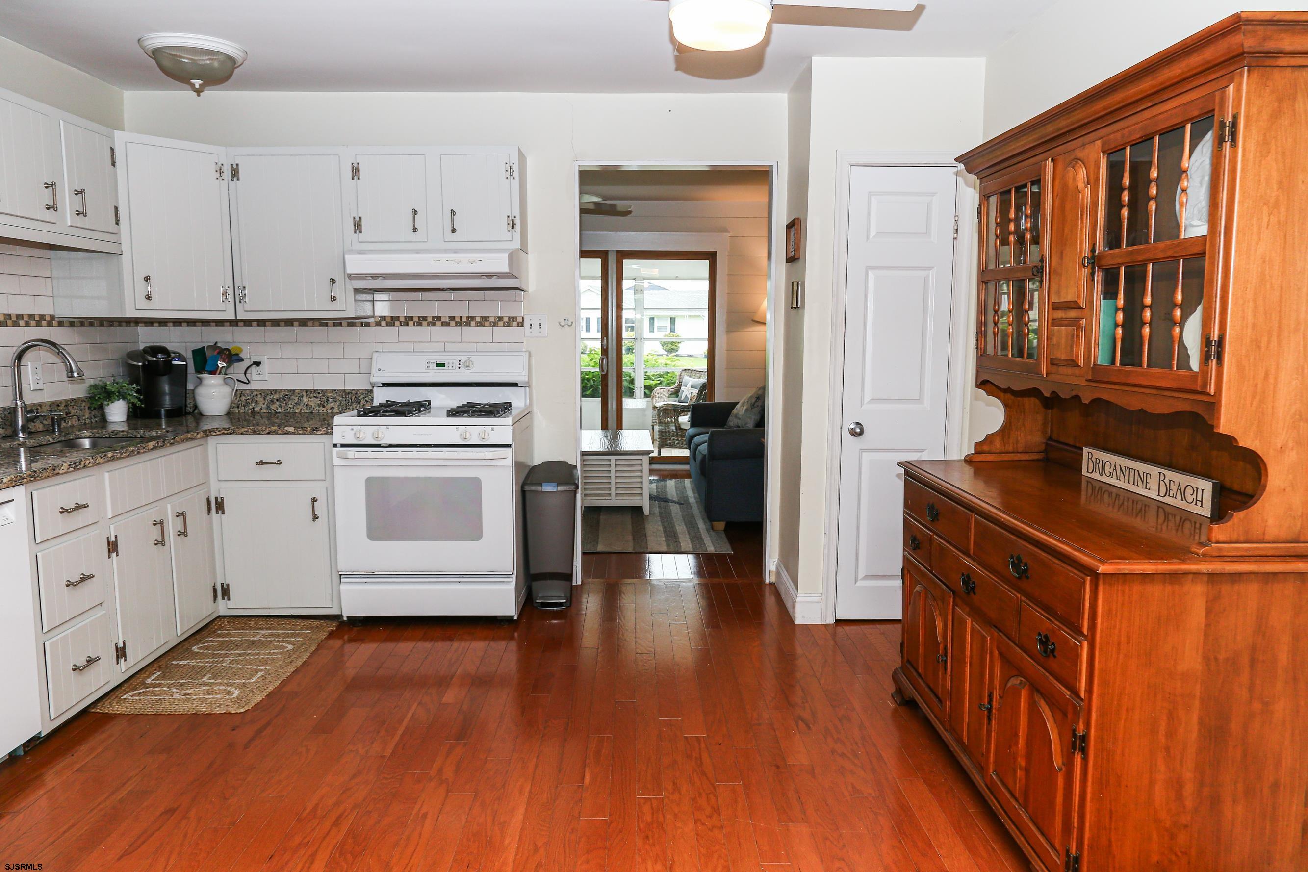 8 44th Cove Brigantine, NJ 08203 - Photo 13 of 57 a kitchen with stainless steel appliances granite countertop a stove and cabinets