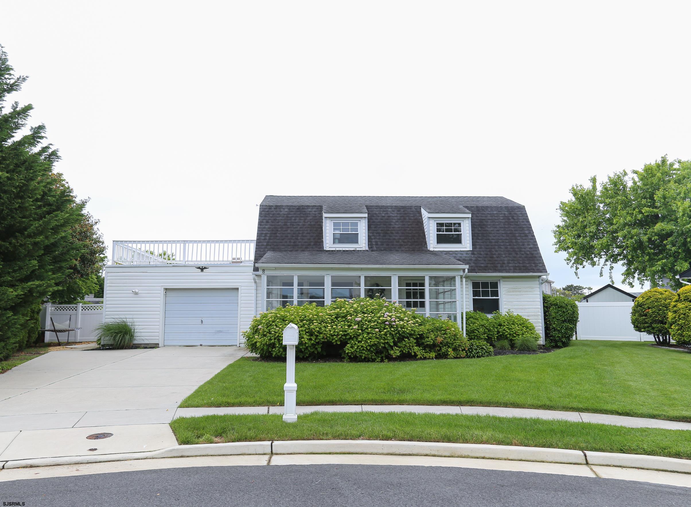 8 44th Cove Brigantine, NJ 08203 - Photo 2 of 57 a front view of a house with a garden