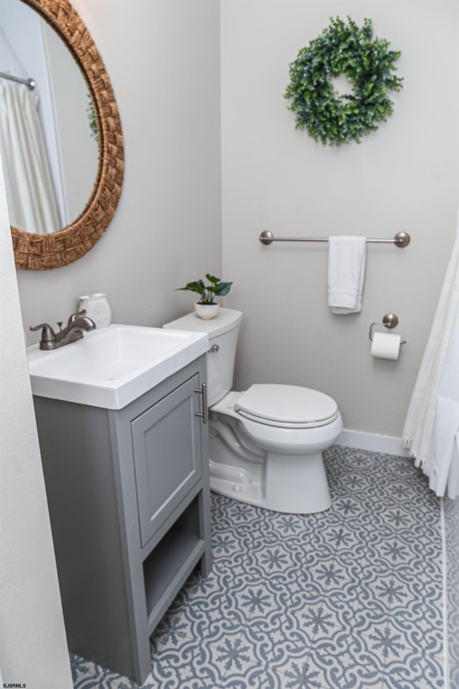8 44th Cove Brigantine, NJ 08203 - Photo 24 of 57 a bathroom with a sink toilet and mirror