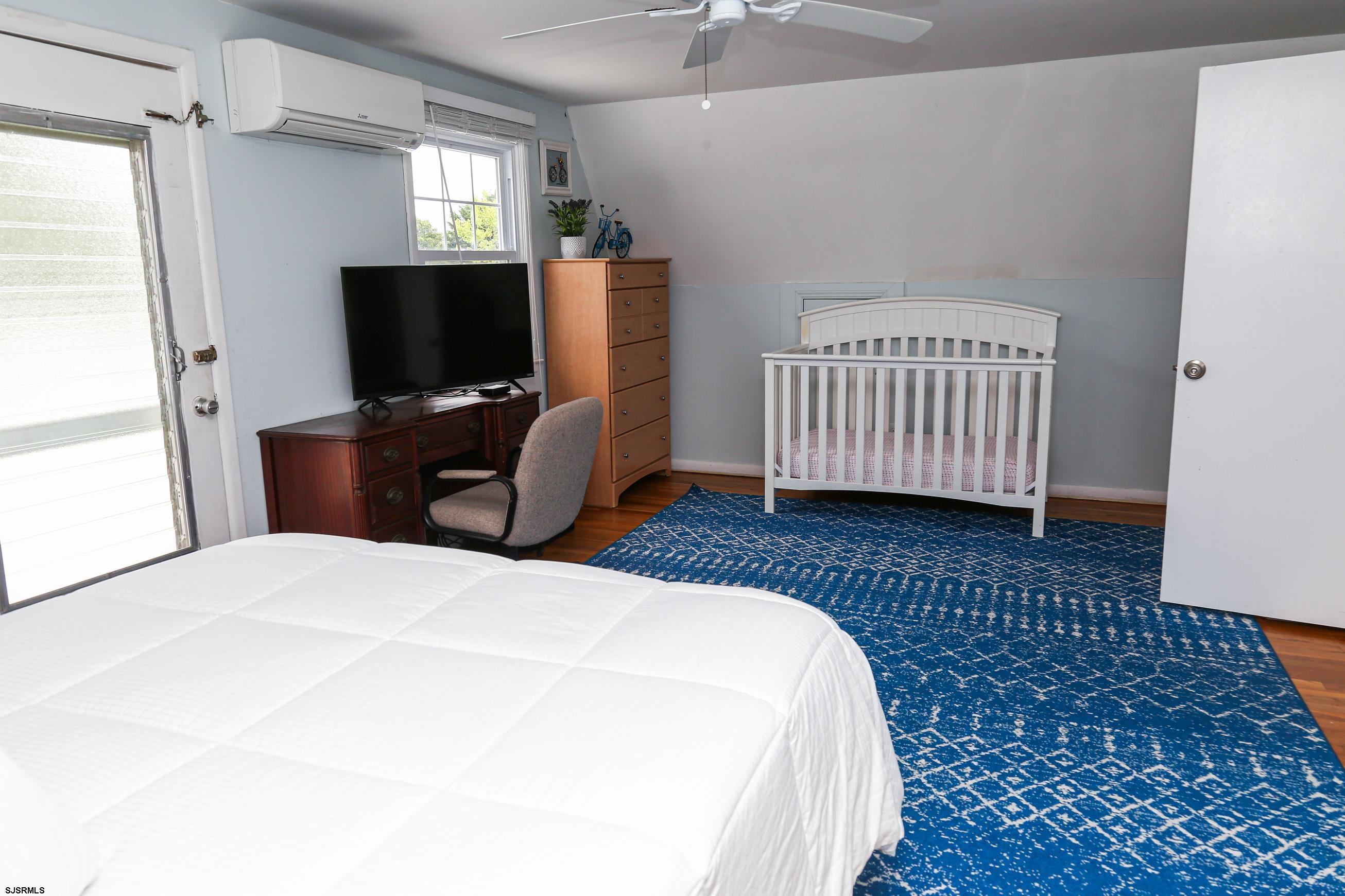 8 44th Cove Brigantine, NJ 08203 - Photo 32 of 57 a bedroom with a bed and a flat screen tv