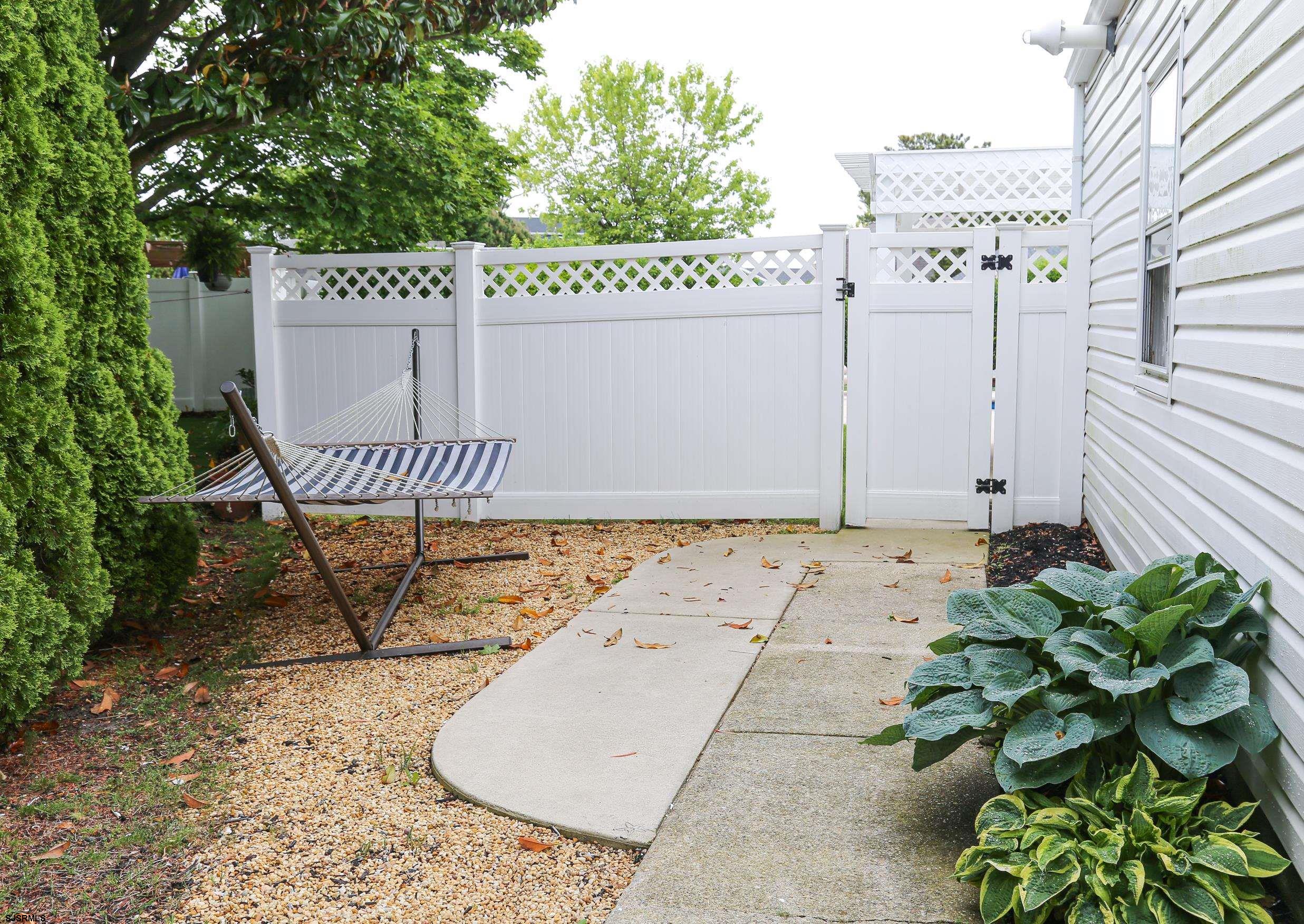 8 44th Cove Brigantine, NJ 08203 - Photo 4 of 57 a view of a wooden bench with potted plants