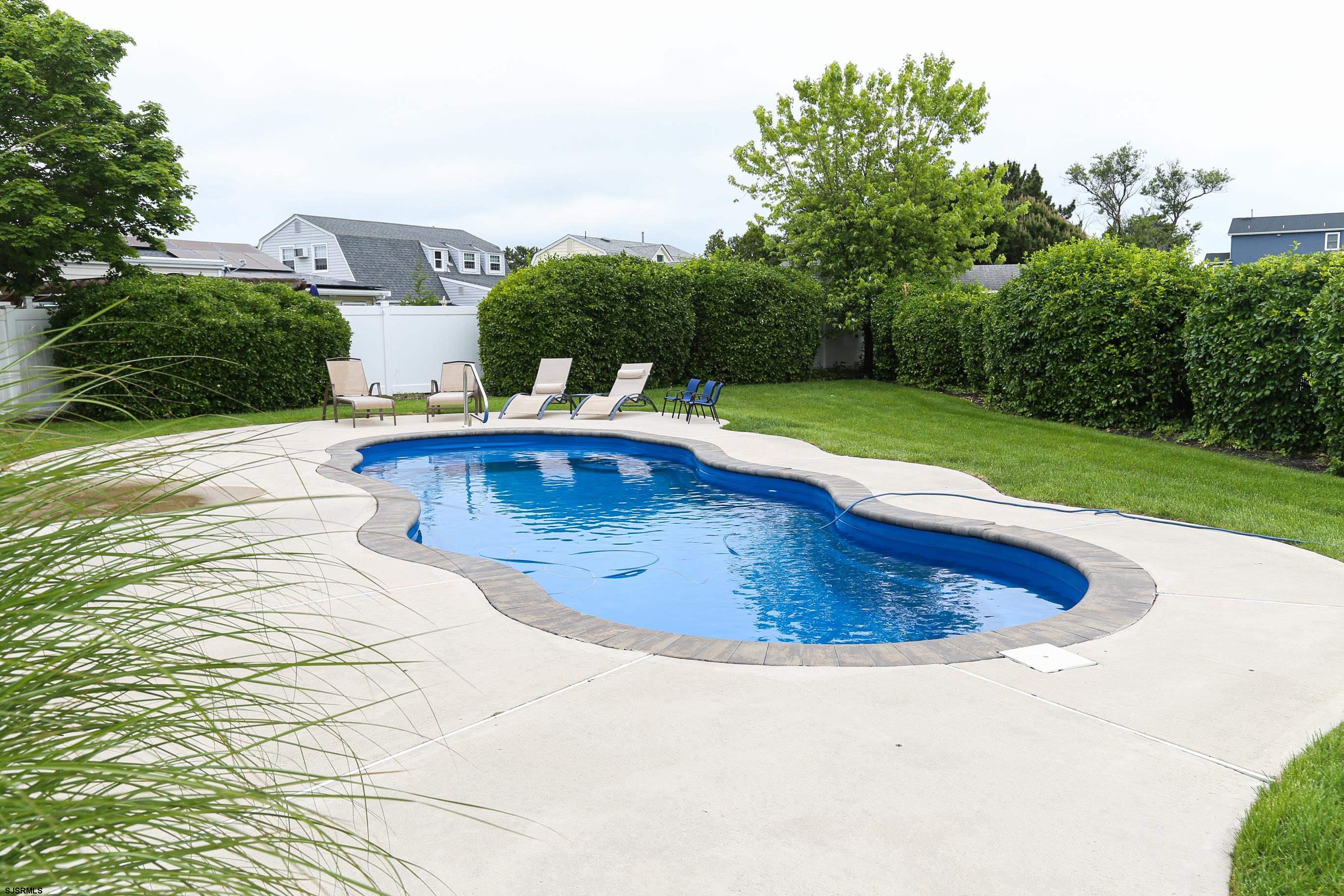 8 44th Cove Brigantine, NJ 08203 - Photo 45 of 57 a view of a swimming pool with a yard