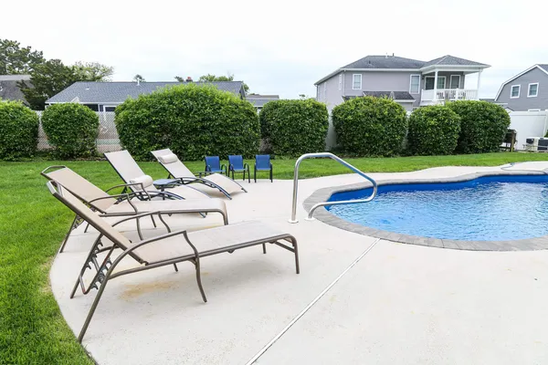 a view of a backyard with swimming pool