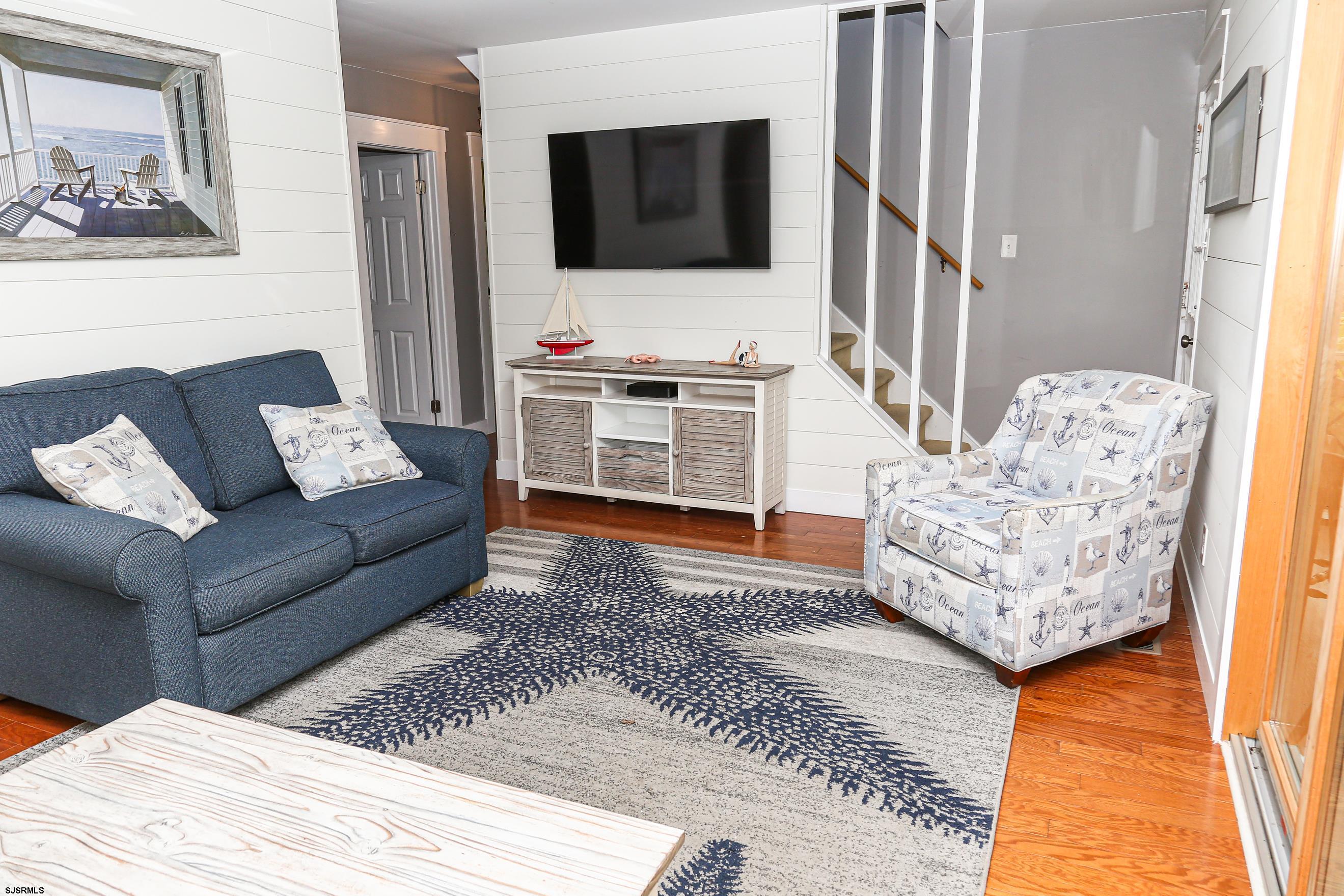 8 44th Cove Brigantine, NJ 08203 - Photo 10 of 57 a living room with furniture and a flat screen tv