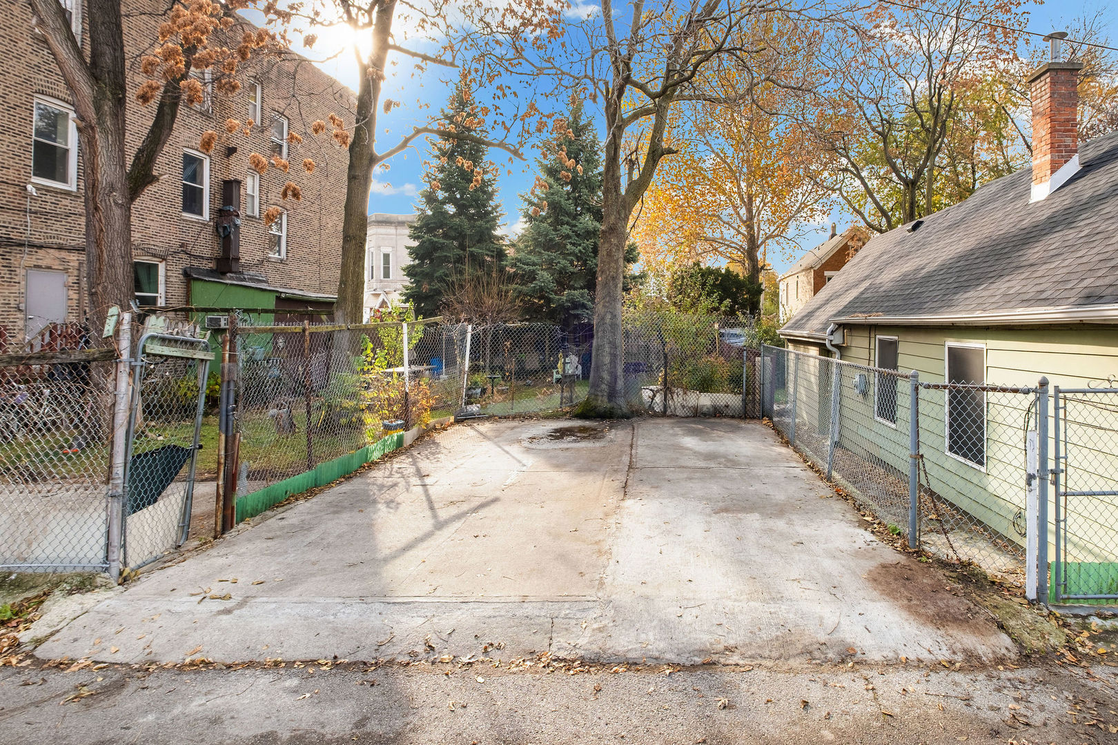2606 West 24th Place Chicago, IL 60608 - Photo 6 of 6 a view of backyard with large trees and a wooden fence