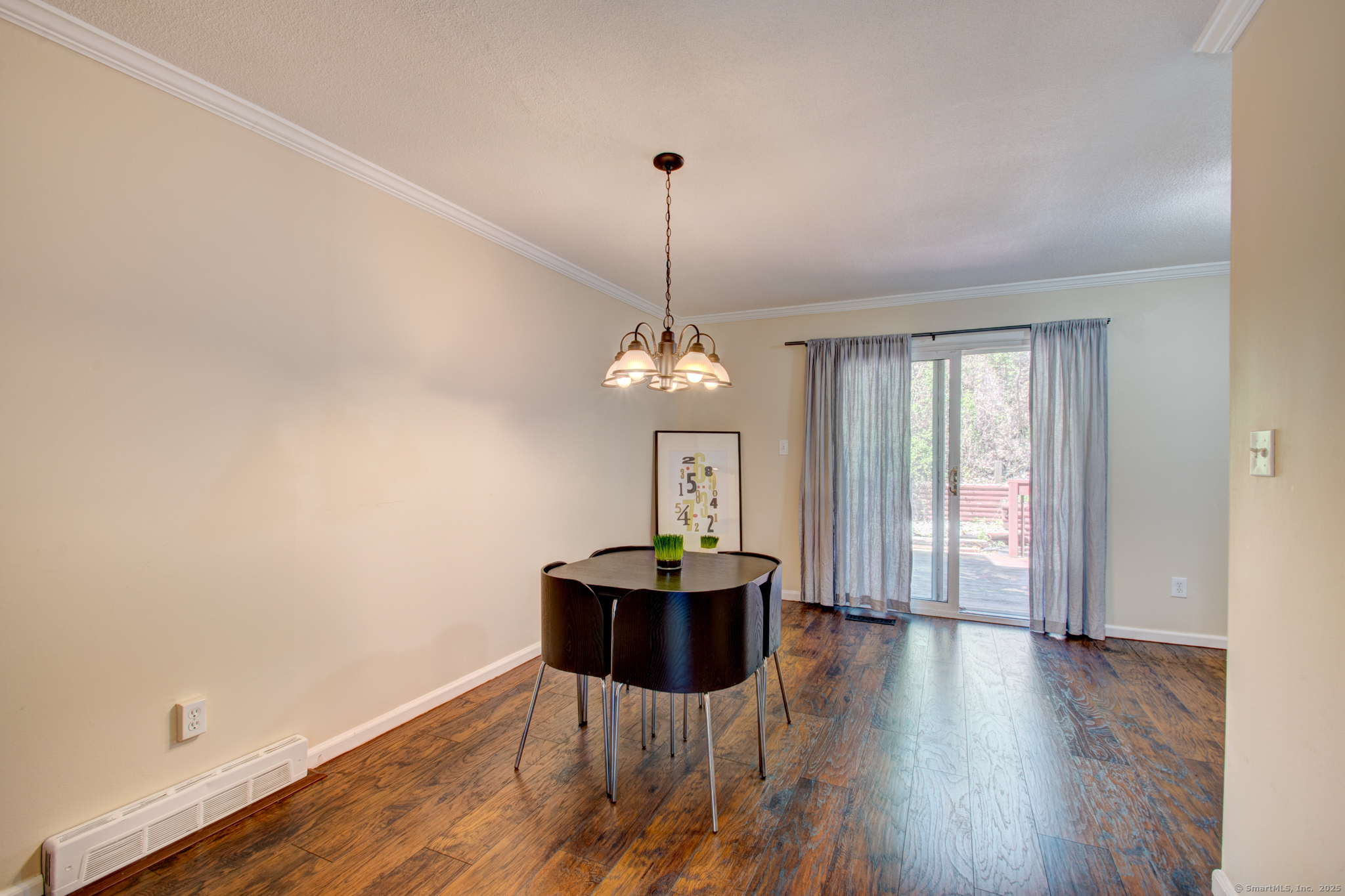 184 Gravel Street, Unit 26 Meriden, CT 06450 - Photo 3 of 27 a dining room with wooden floor a chandelier a glass table and chairs