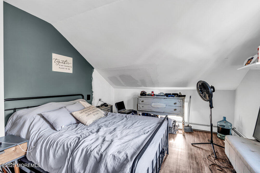 235 Perrineville Road Jackson, NJ 08527 - Photo 12 of 20 a bedroom with a bed and wooden floor