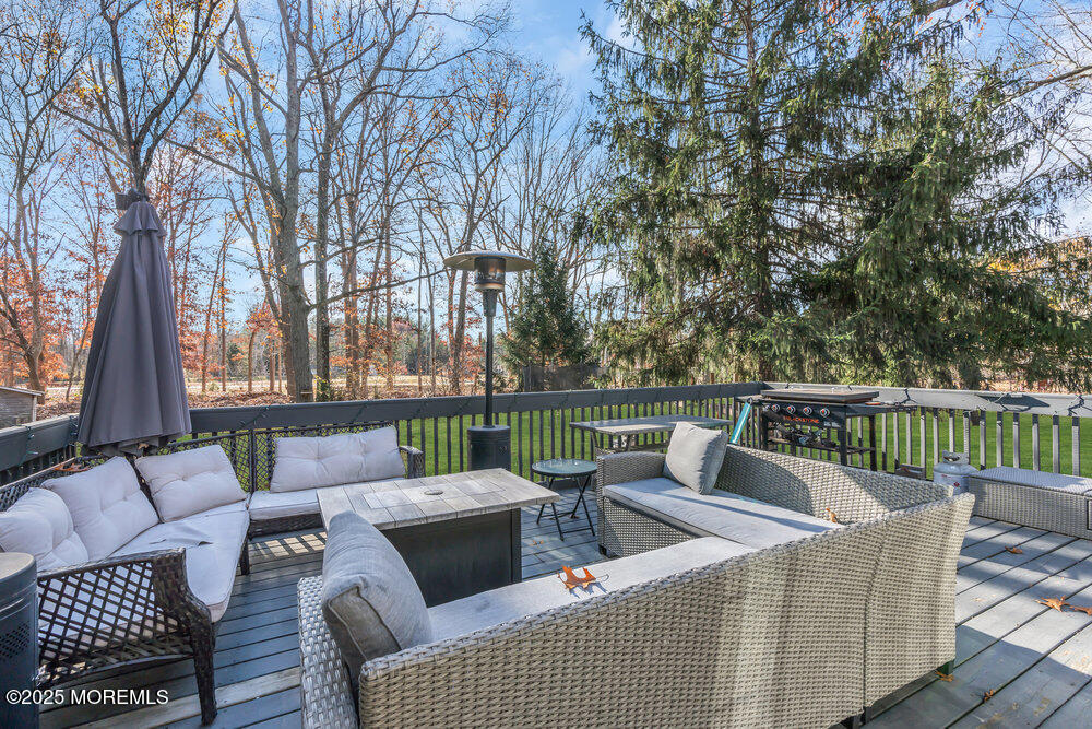 235 Perrineville Road Jackson, NJ 08527 - Photo 18 of 20 a view of a patio with couches chairs and a table and chairs