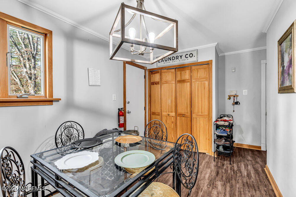 235 Perrineville Road Jackson, NJ 08527 - Photo 9 of 20 a dining room with furniture and wooden floor