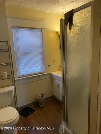a bathroom with a toilet and a shower