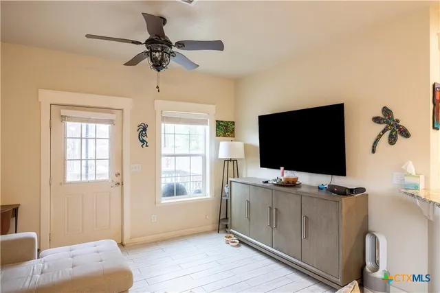 a bedroom with furniture and a flat screen tv