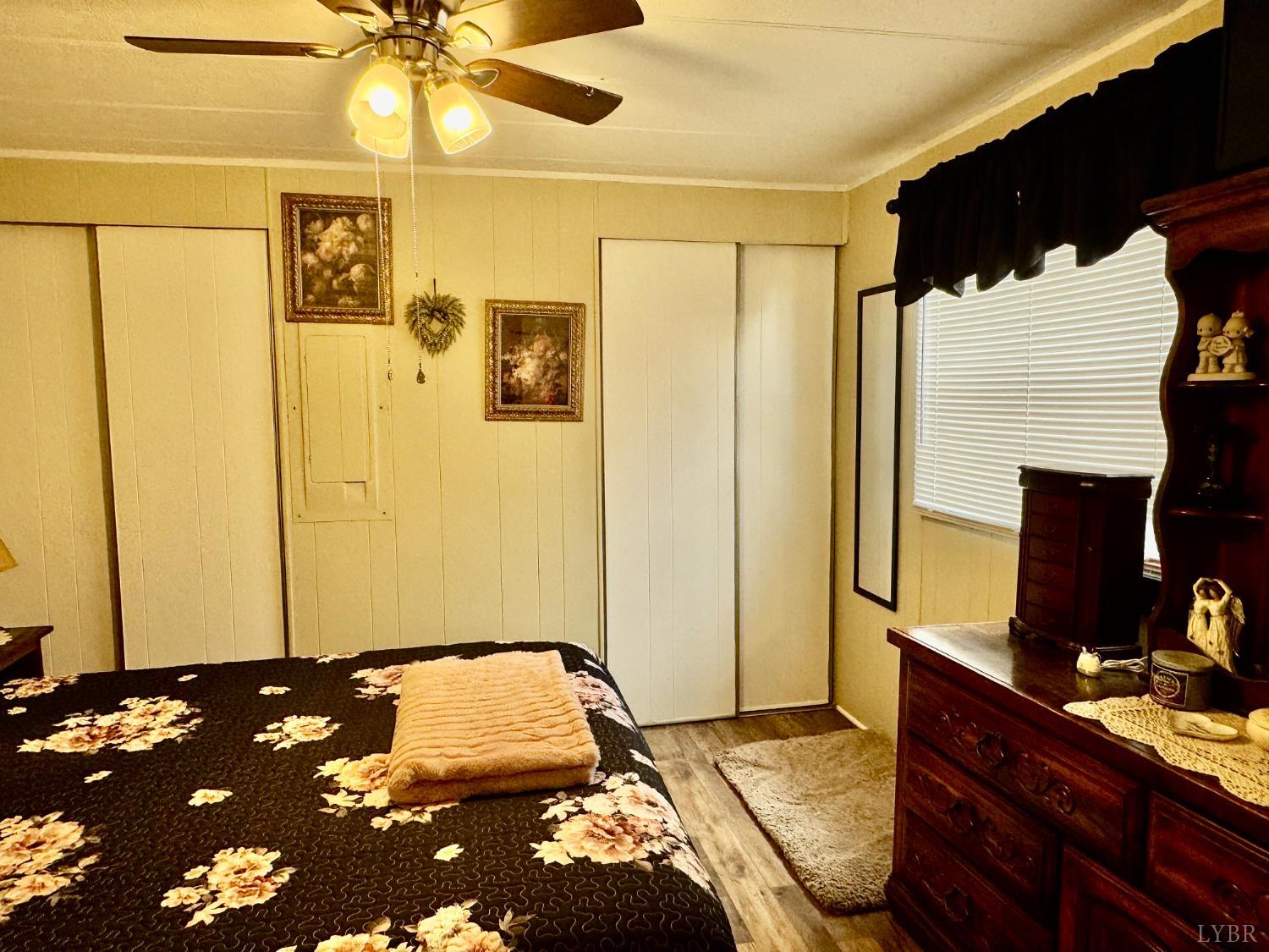 6223 Joppa Mill Road Moneta, VA 24121 - Photo 40 of 55 a bedroom with a bed and a chandelier