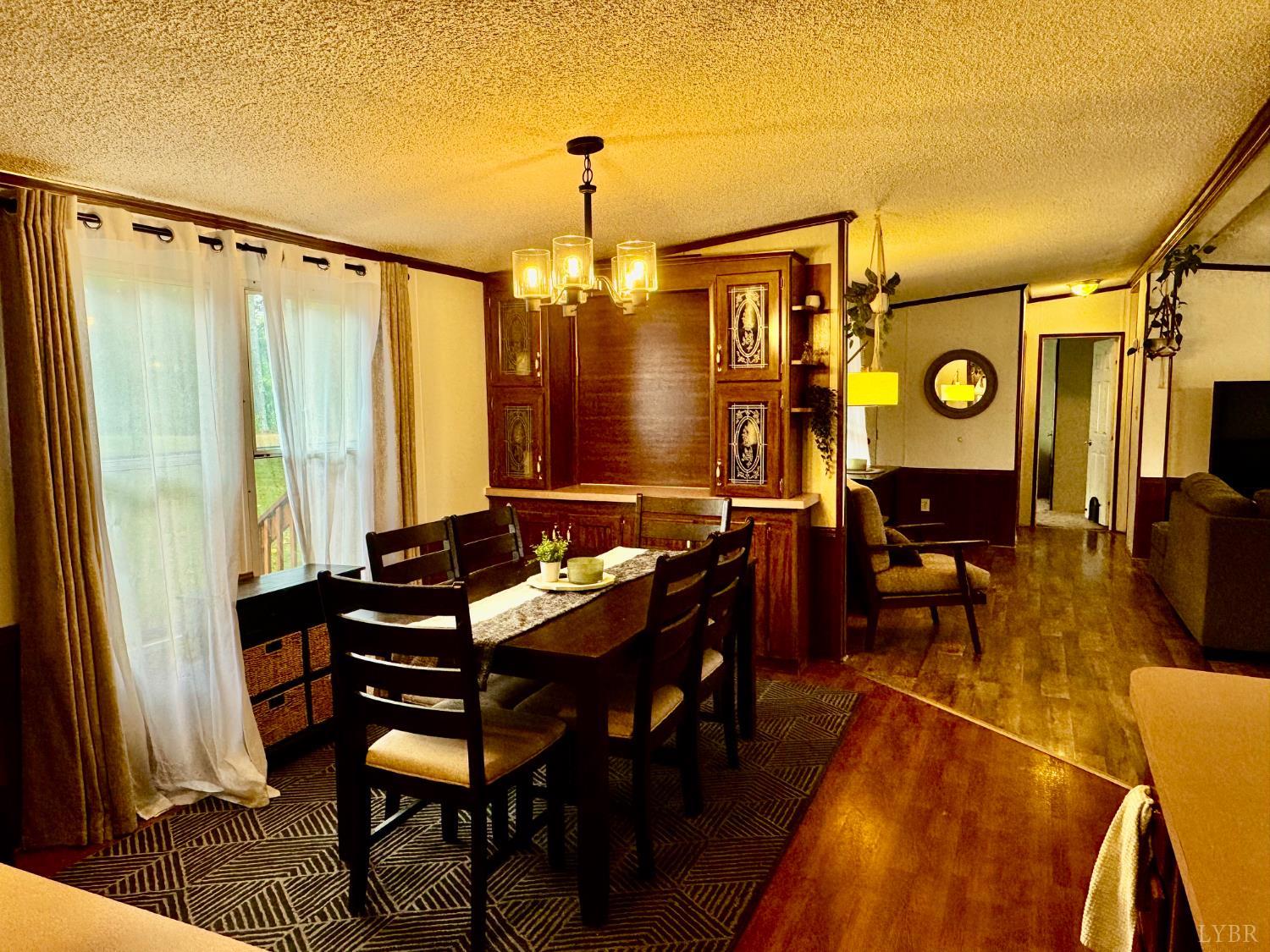 6223 Joppa Mill Road Moneta, VA 24121 - Photo 8 of 55 a view of a dinning room with furniture window and wooden floor