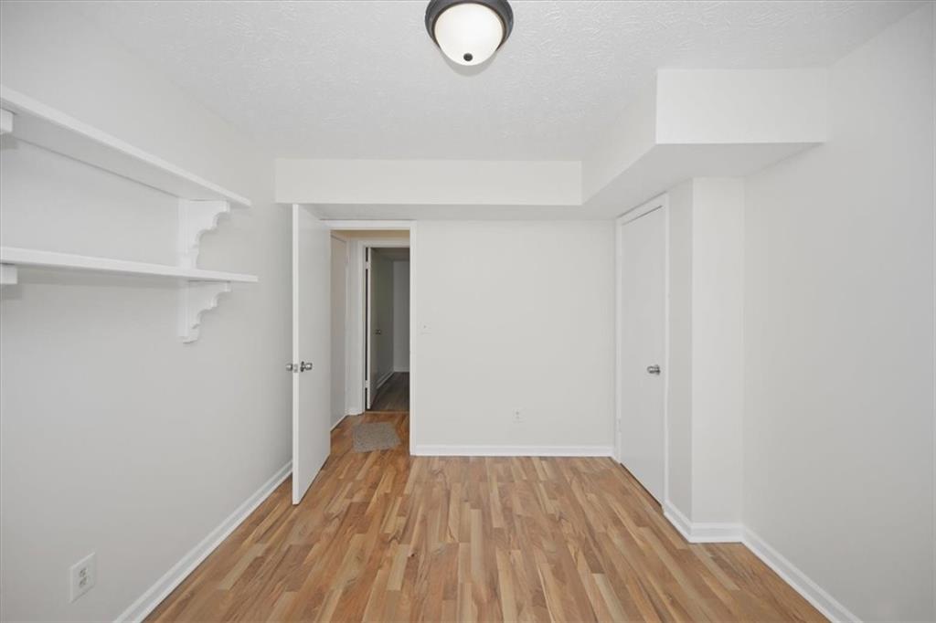 1496 Cherry Hill Road Southwest Conyers, GA 30094 - Photo 11 of 32 a view of a room with wooden floor and white walls