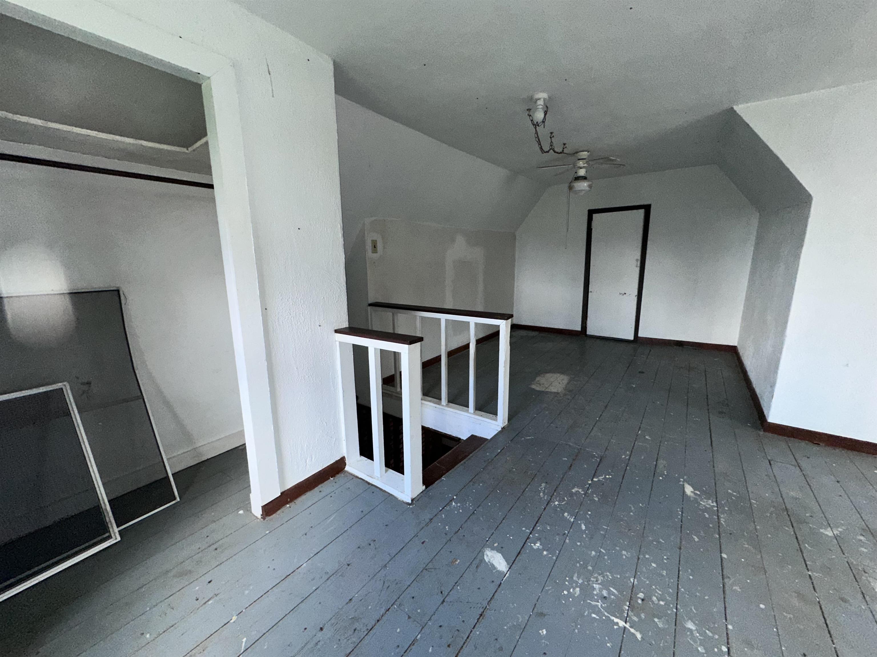 2855 West Florence Road Freeport, IL 61032 - Photo 8 of 13 a view of an empty room with wooden floor and a window