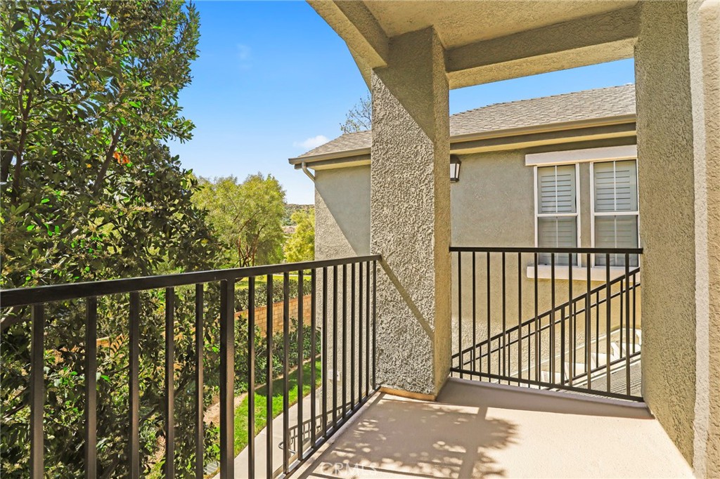 20000 Plum Canyon Road, Unit 1722 Saugus, CA 91350 - Photo 20 of 30 a view of a balcony with a floor to ceiling window and wooden fence