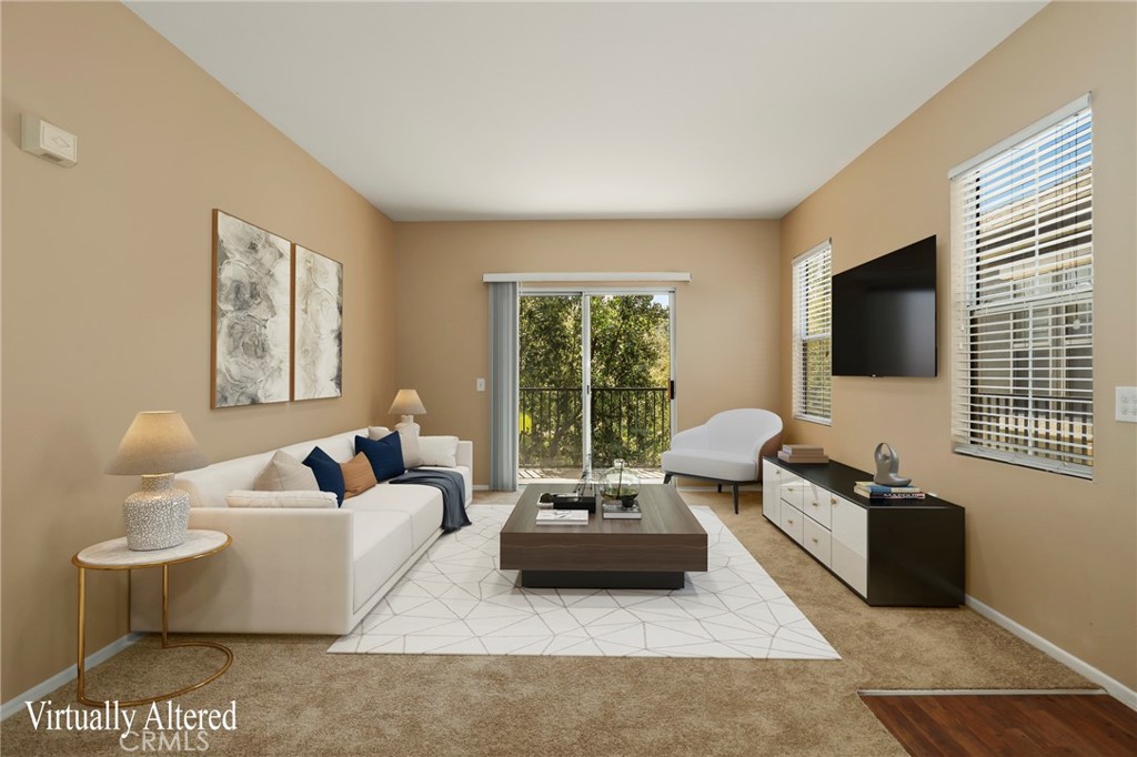 20000 Plum Canyon Road, Unit 1722 Saugus, CA 91350 - Photo 2 of 30 a living room with furniture a flat screen tv and a window