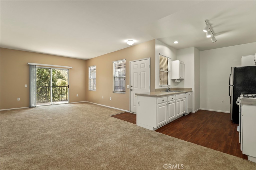 20000 Plum Canyon Road, Unit 1722 Saugus, CA 91350 - Photo 6 of 30 a large white kitchen with cabinets and a refrigerator