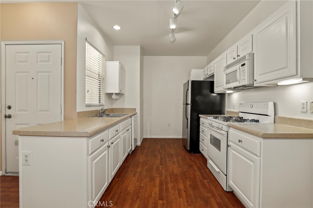 20000 Plum Canyon Road, Unit 1722 Saugus, CA 91350 - Photo 8 of 30 a kitchen with stainless steel appliances granite countertop a stove and a refrigerator
