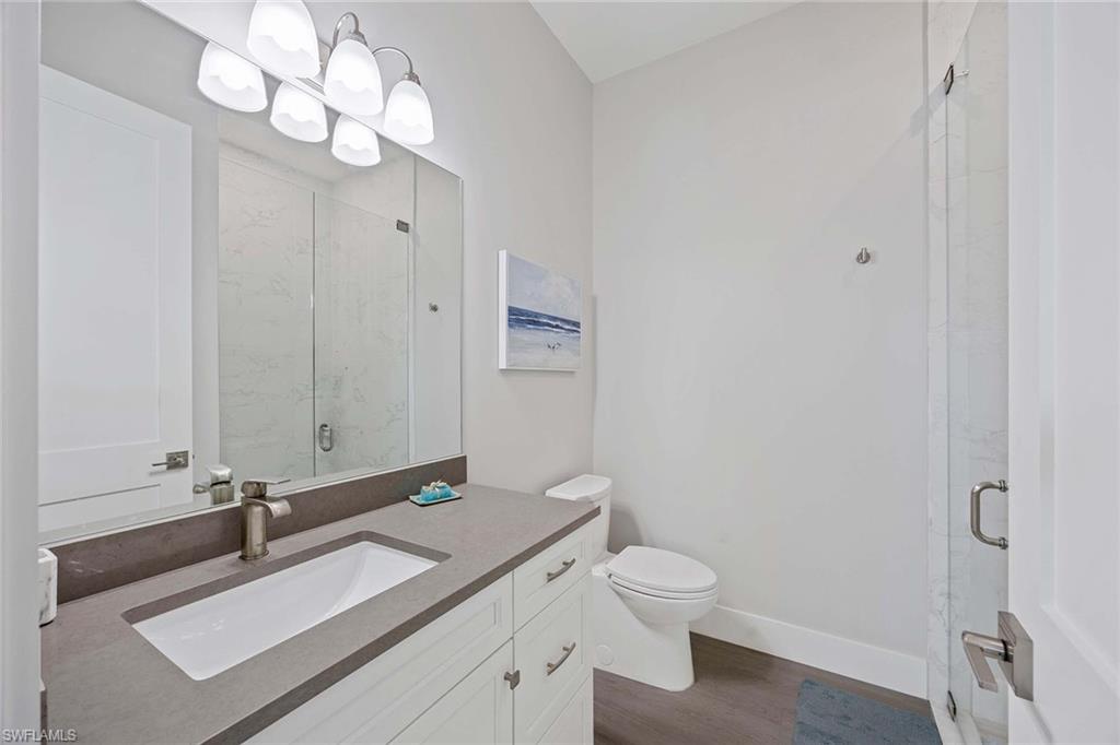 1395 Curlew Avenue, Unit 43 Naples, FL 34102 - Photo 16 of 24 a bathroom with a sink a toilet and a mirror
