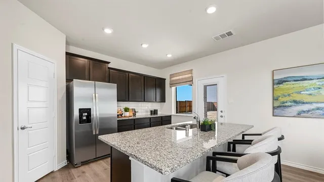a kitchen with granite countertop a sink and a counter top space