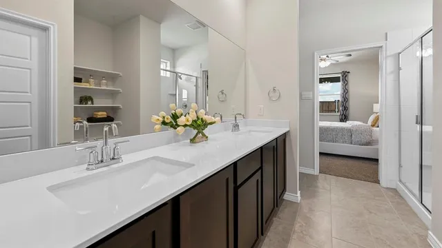 a en suite bathroom with a sink double vanity and a mirror