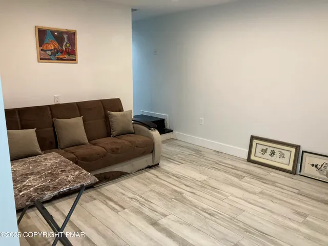 a bedroom with a bed and large windows