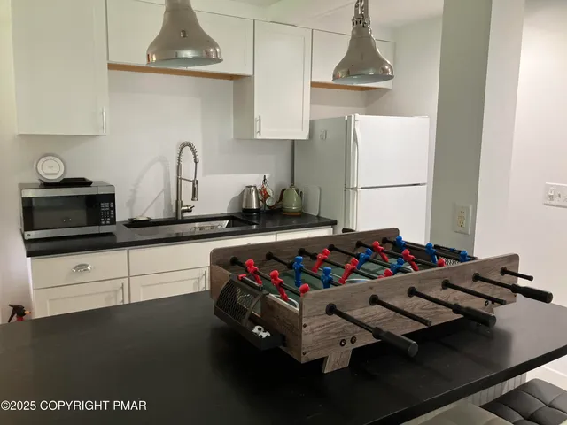 a view of a dining room with furniture and a chandelier