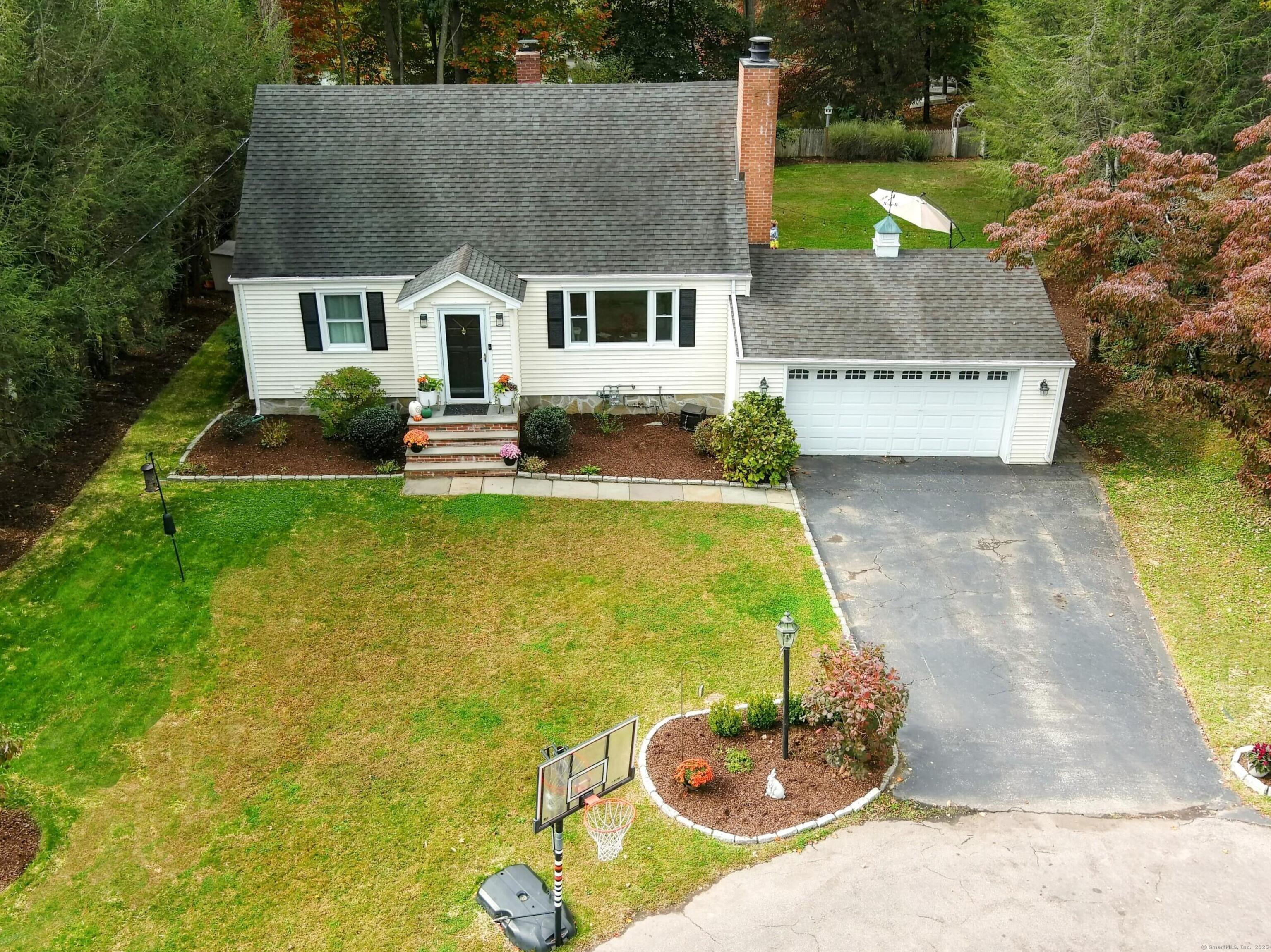 a aerial view of a house with swimming pool garden and patio