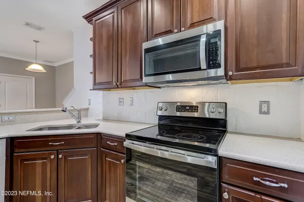 a kitchen with a stove microwave and sink