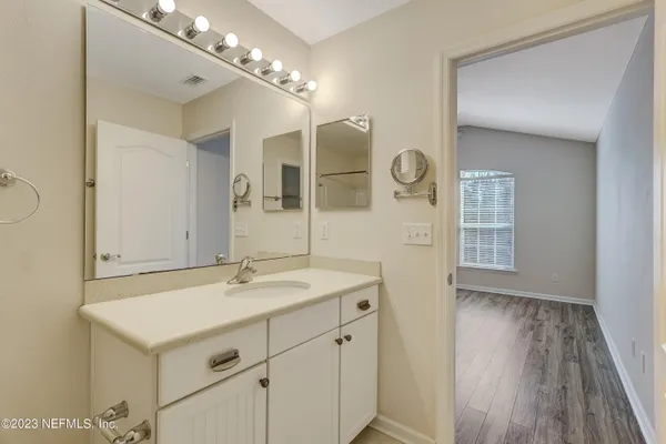 a bathroom with a sink a mirror and a shower