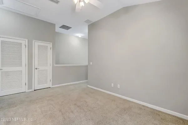 an empty room with closet area