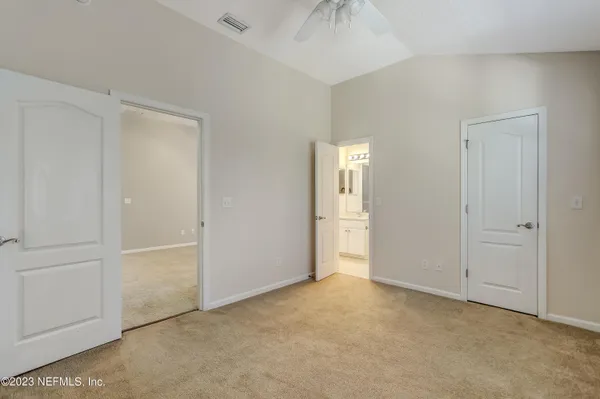 a view of an empty room and a bathroom