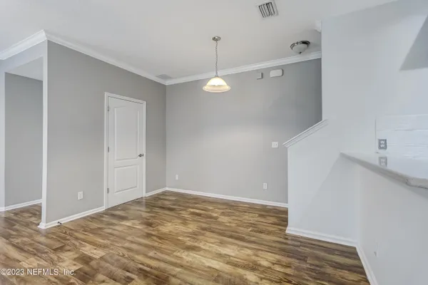 a view of a room with wooden floor and windows