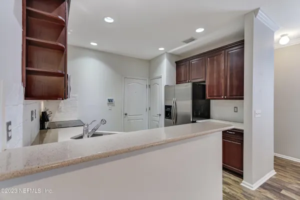a kitchen with refrigerator and cabinets