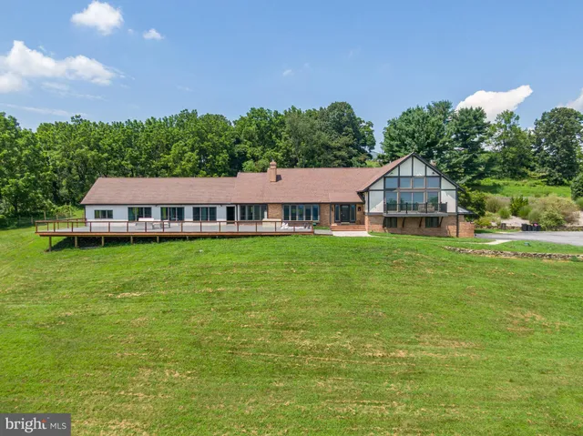 a aerial view of a house with a yard table and chairs