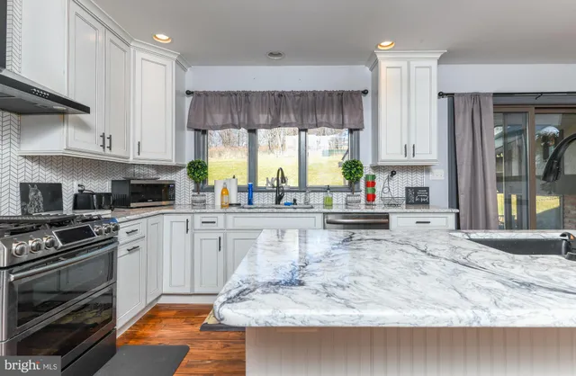 a kitchen with a stove a sink and a refrigerator