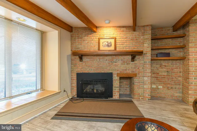 a utility room with a sink a cabinetry and a window