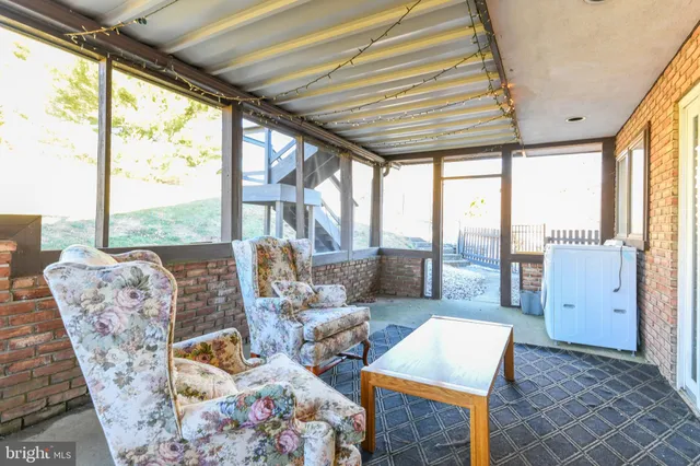 a bed sitting in a spacious bedroom next to a window