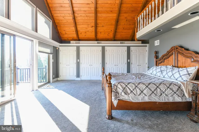 a bedroom with a bed and a television