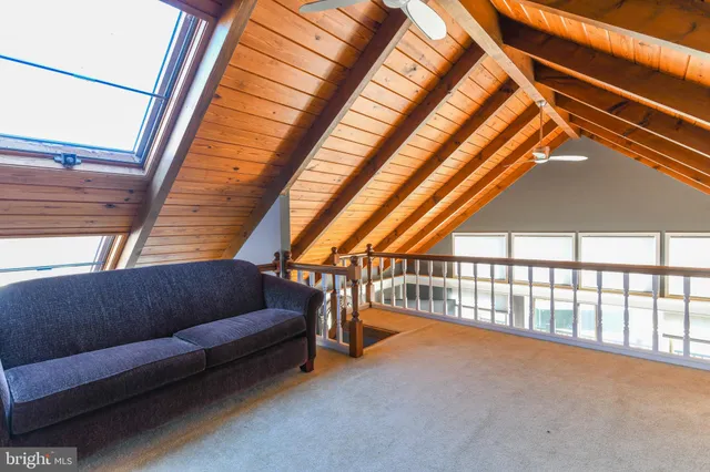 a bathroom with a granite countertop sink a mirror and a bathtub