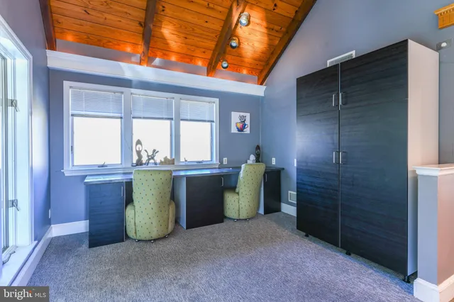 a bedroom with a bed and a chandelier fan