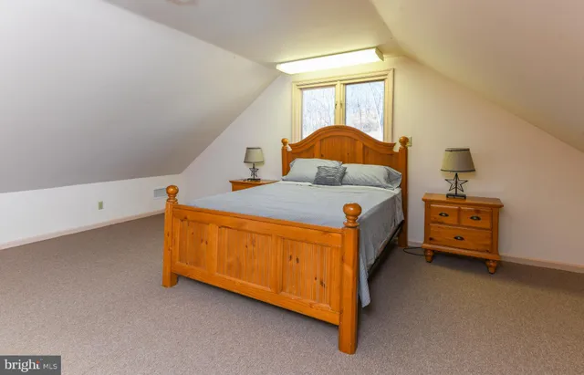a bathroom with a granite countertop toilet sink and mirror