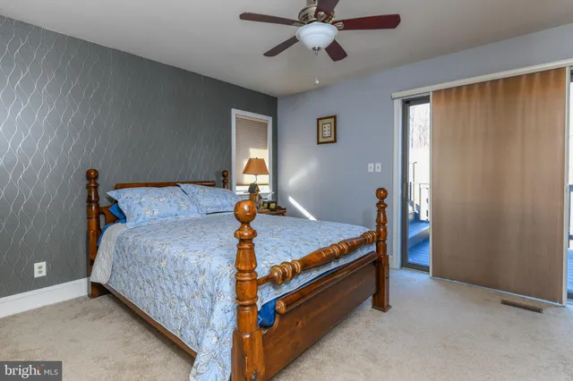 a large white kitchen with sink and large windows