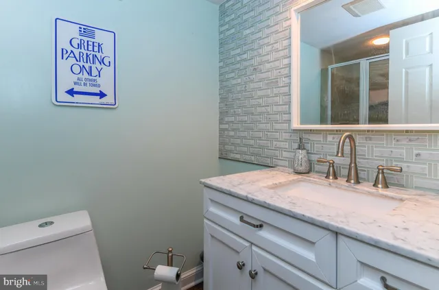 an aerial view of a residential houses with outdoor space and trees all around